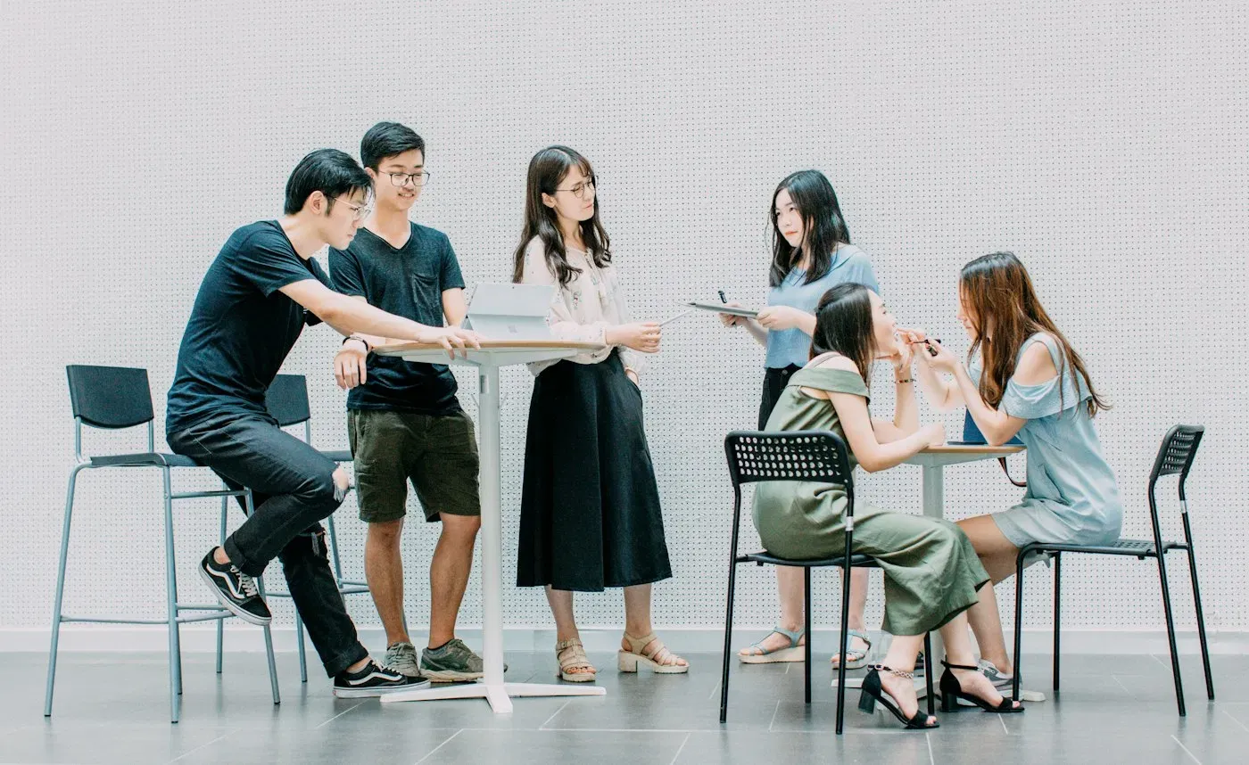 Young founders collaborating around a table in a bright workspace